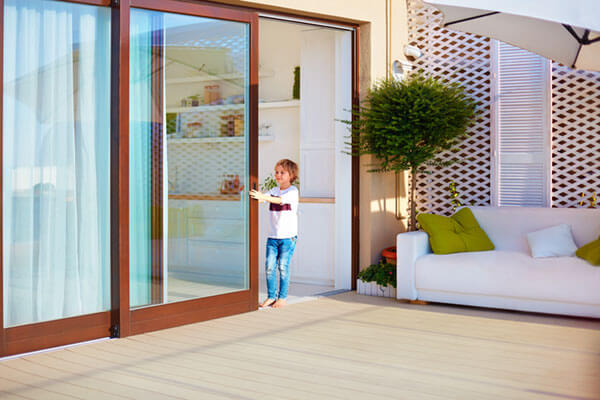 kid opening a sliding glass door