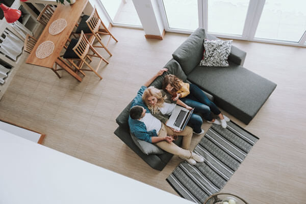 people on laptop hanging in the living room